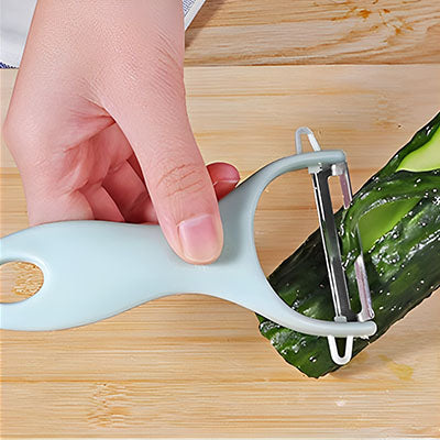 une madame qui utilise un eplucheur bleu en plastique avec une lame en acier inoxydable